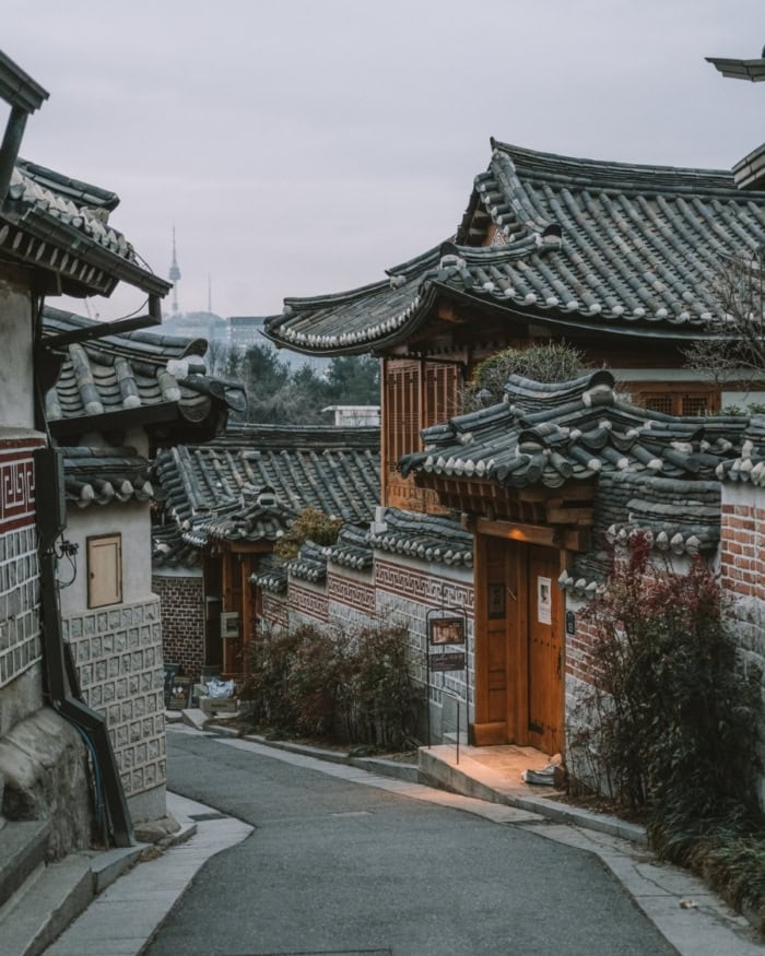 Ornate hanok house gate surrounded by trees