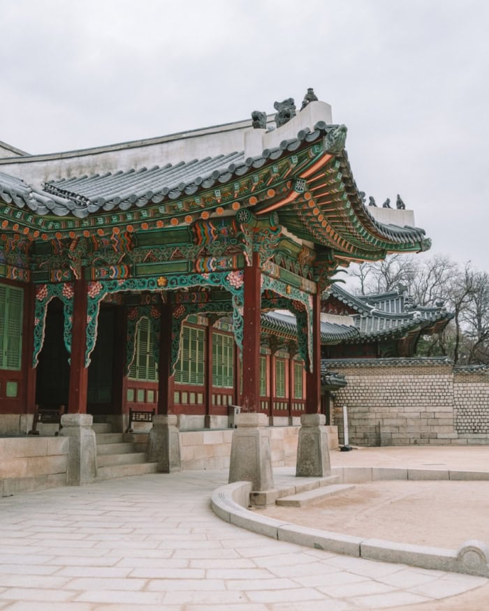 Ornate palace building in shades of green and brown at Changdeokgung Palace