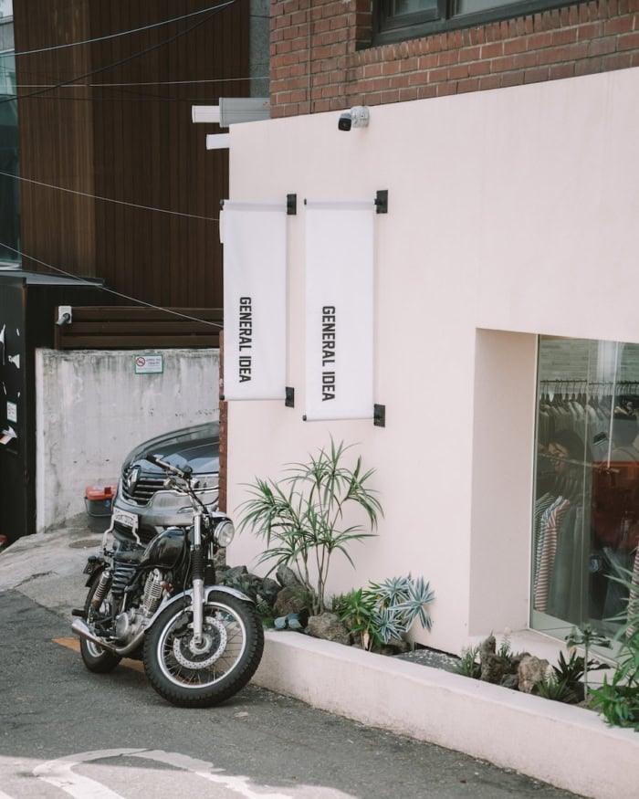 Exterior of store called General Idea with motorcycle parked out front