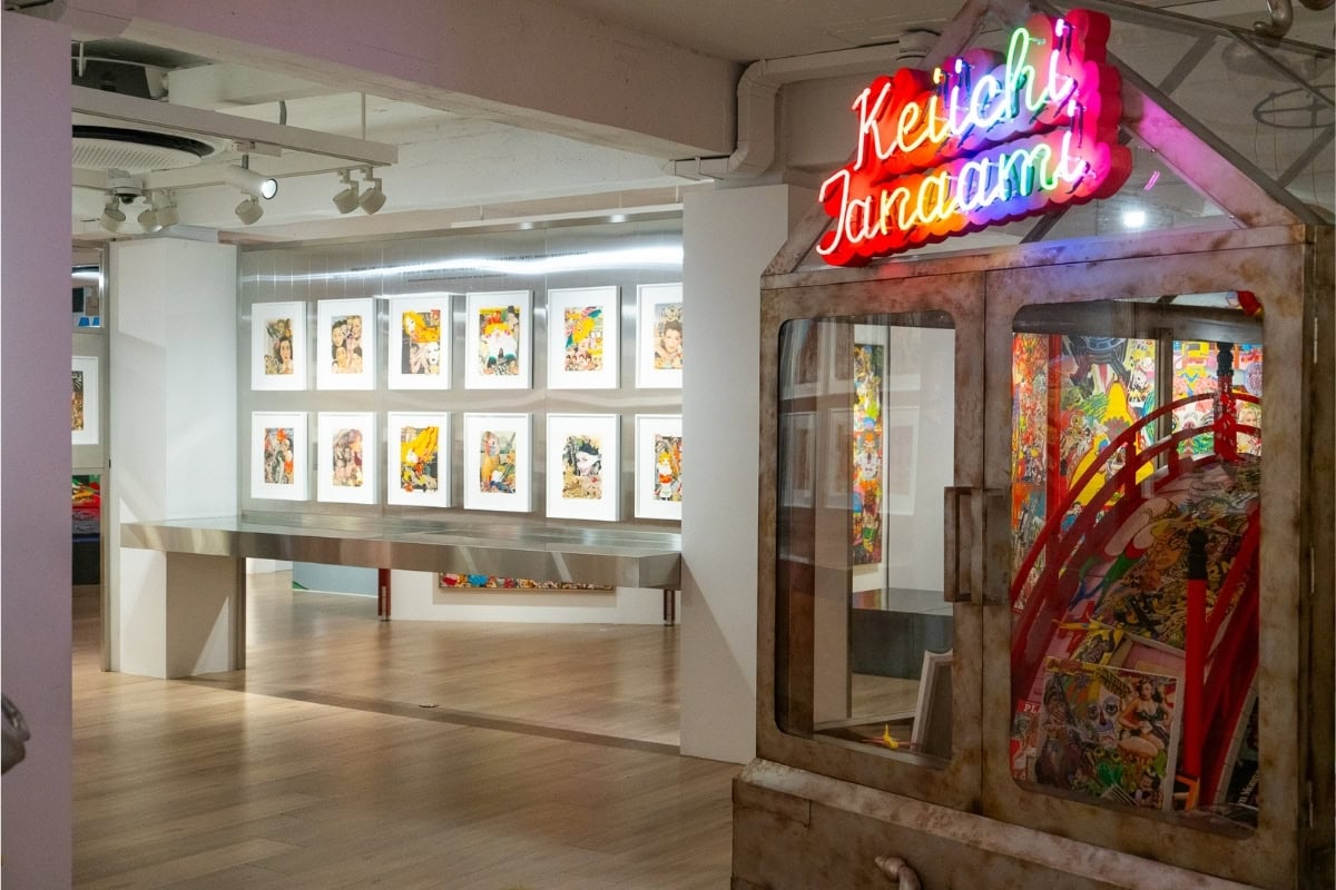 Interior of an art gallery featuring neon signs on the wall.