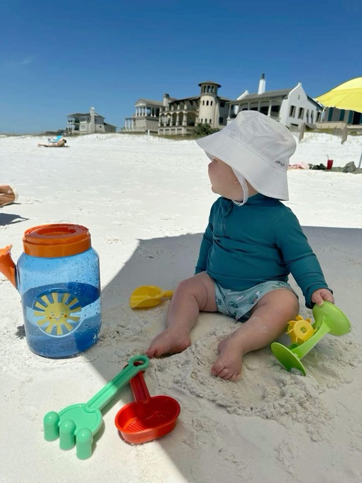 Chụp bé ngồi bên tháp cát vừa xây xong