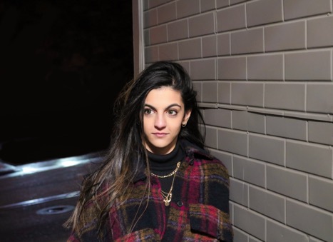 Jenna Dewji in front of tiled wall