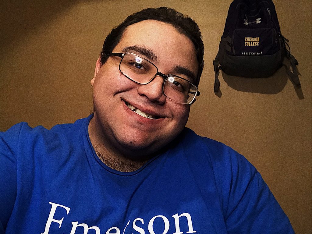 Anthony Rodriguez in Emerson T-shirt with Emerson backpack hanging behind him