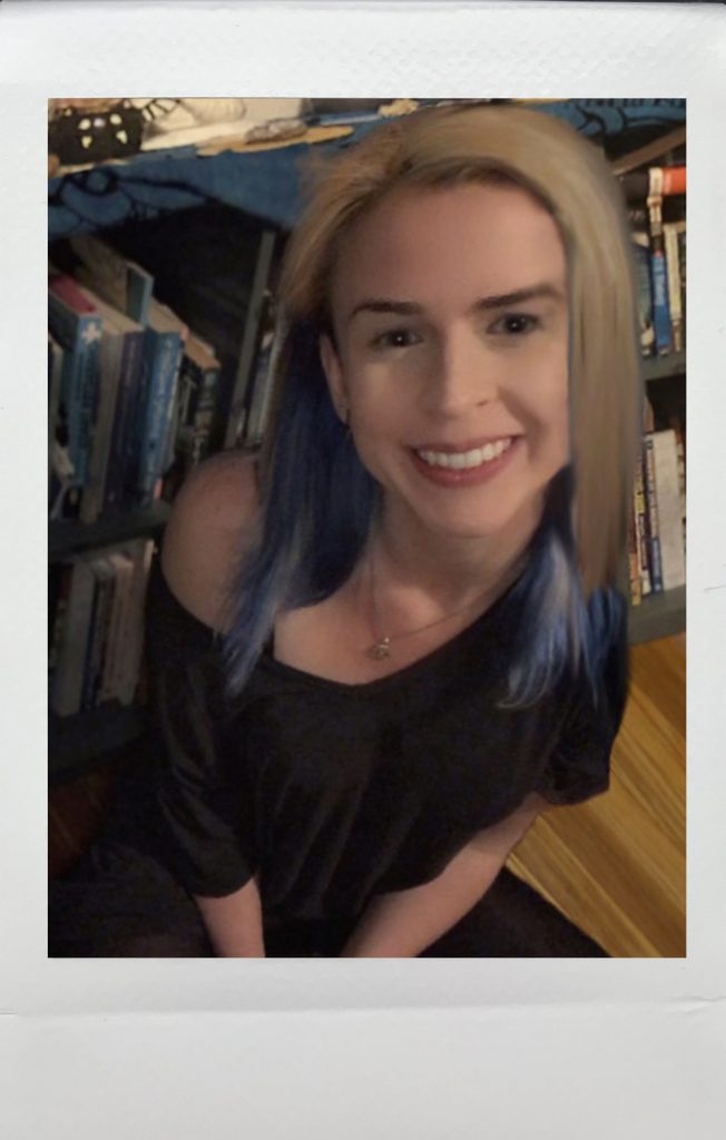 Mikaela Joyce in front of book shelf