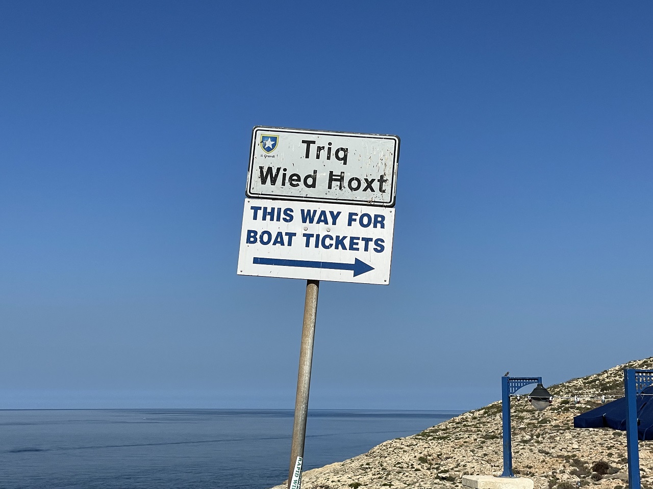 Signage pointing to the Blue Grotto ticket booth