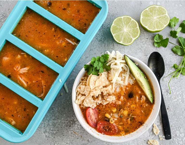 Souper Cubes 1-cup tray and ceramic bowl filled with chicken tortilla soup.