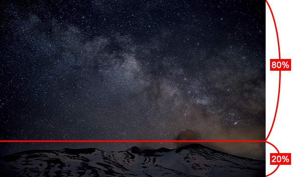 Starry sky over snowy mountains