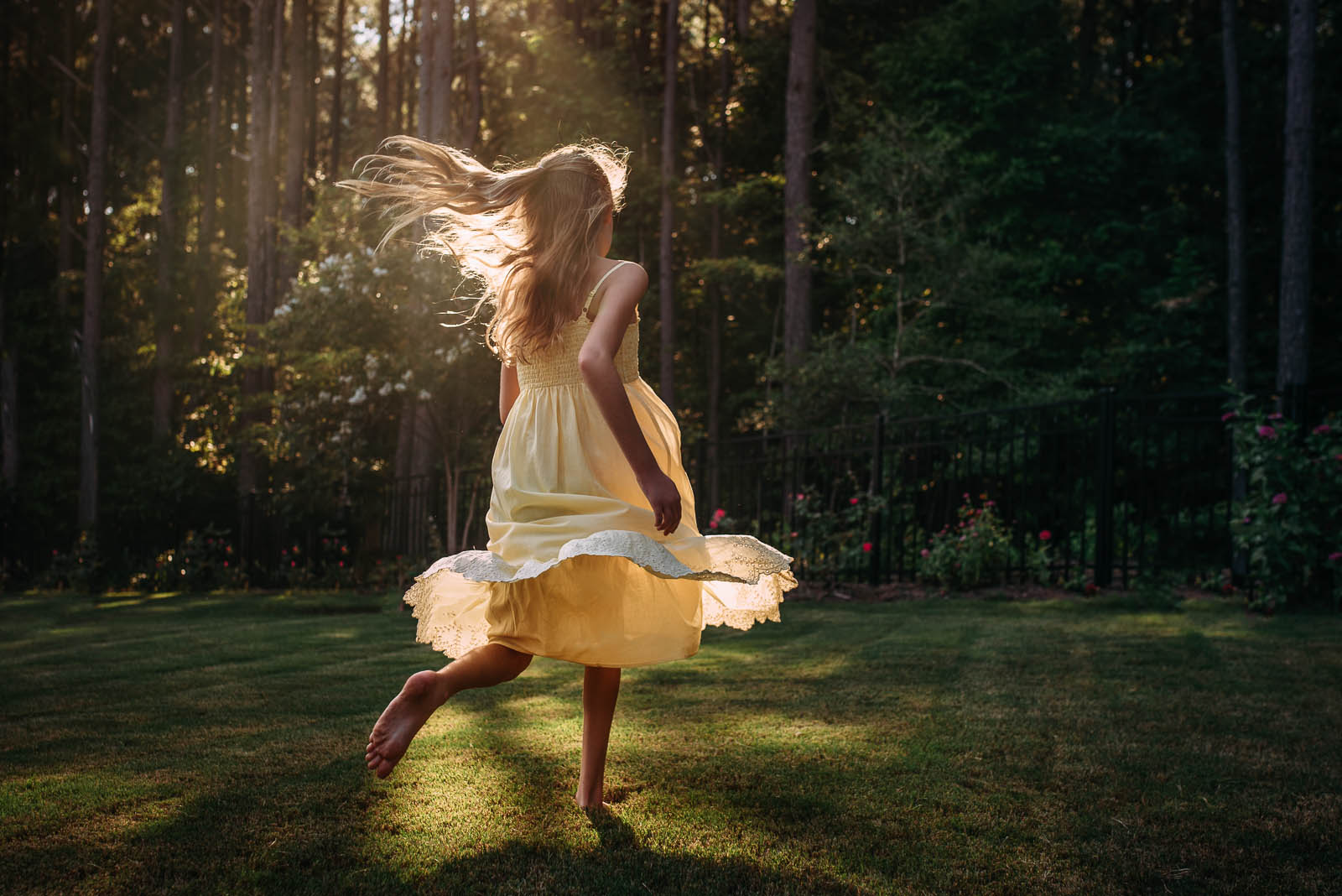backlit photo of girl in a yellow sundress by Susan Grimes