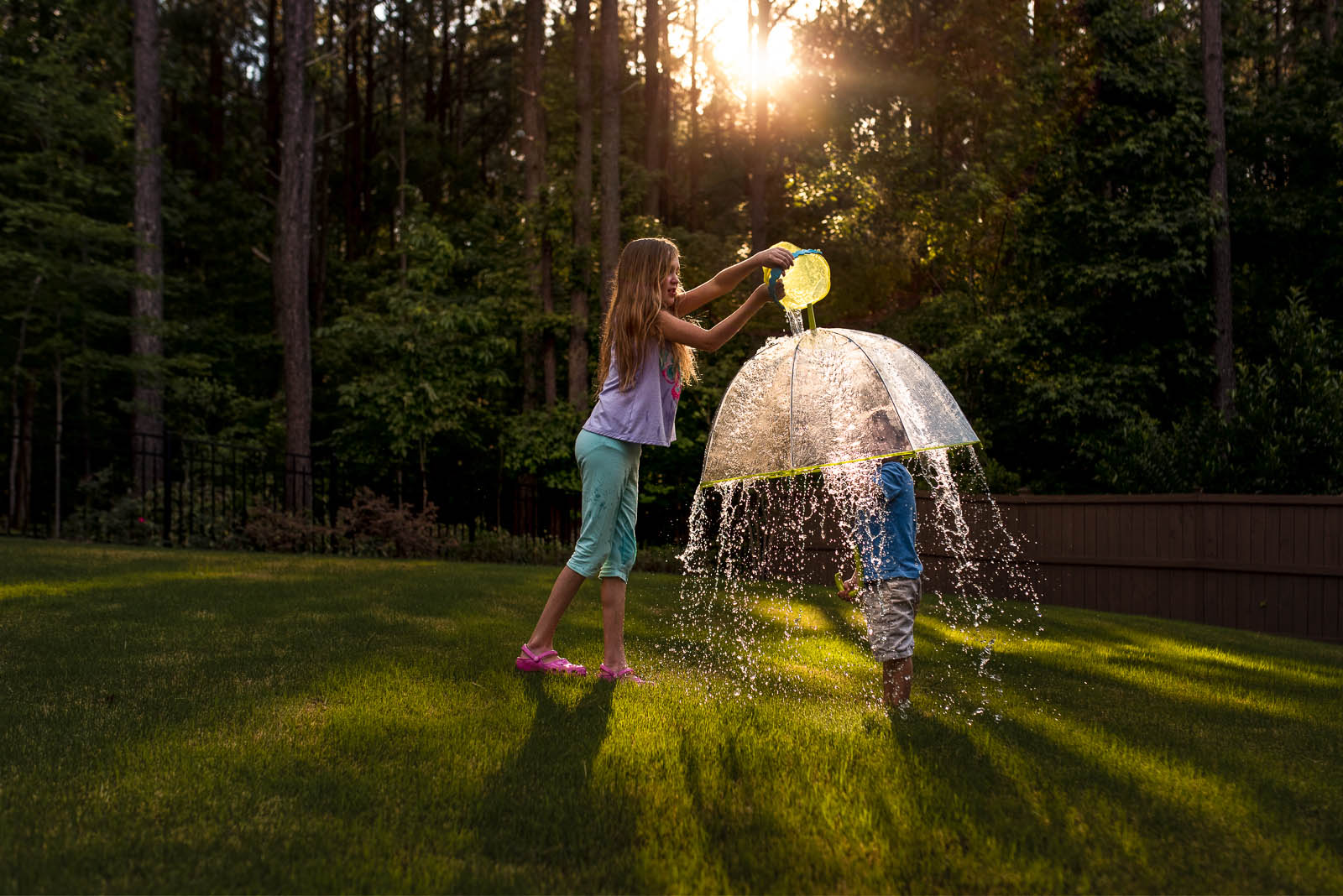 photo of sister dropping water on brother by Susan Grimes