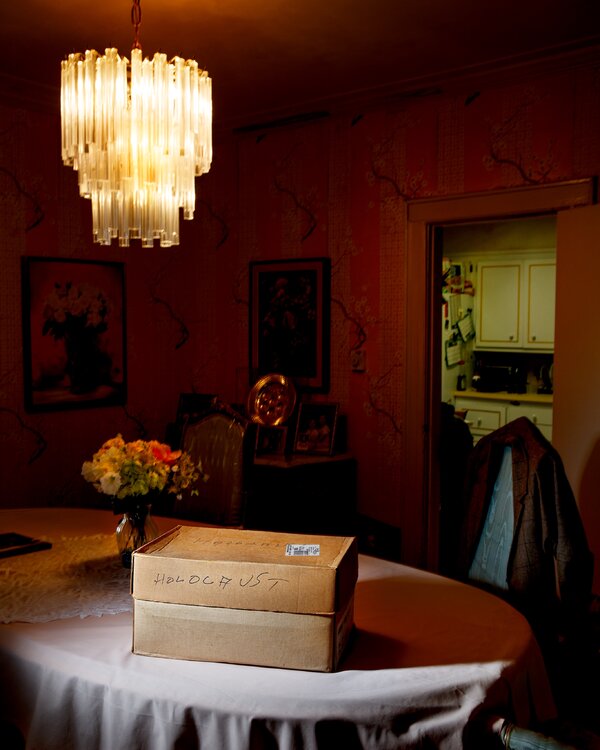 A box of artifacts labeled “Holocaust” on a table.